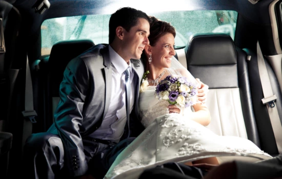 Groom and Bride sitting in a luxury limousine