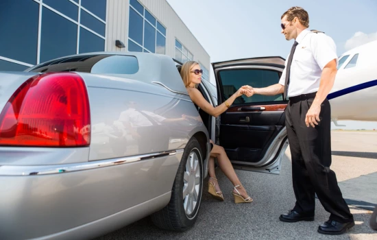 A woman getting out of a limo at airport